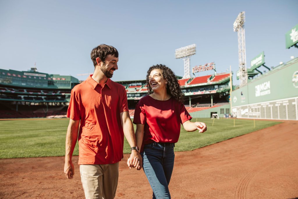 Couple poses for their Boston engagement photos at Fenway Park