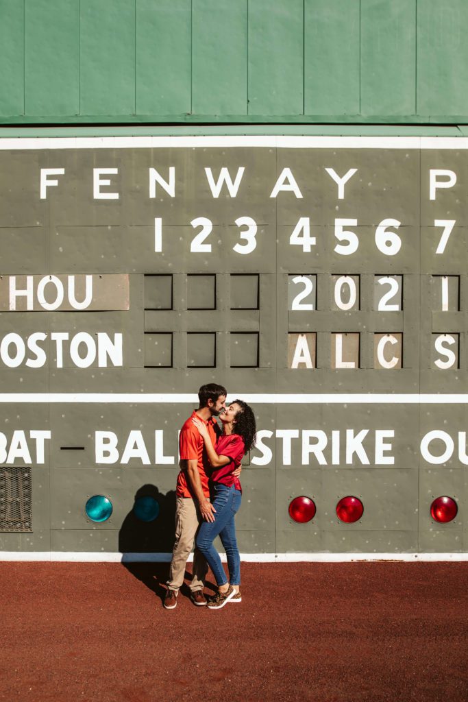 Couple poses for Boston engagement photos at Fenway Park