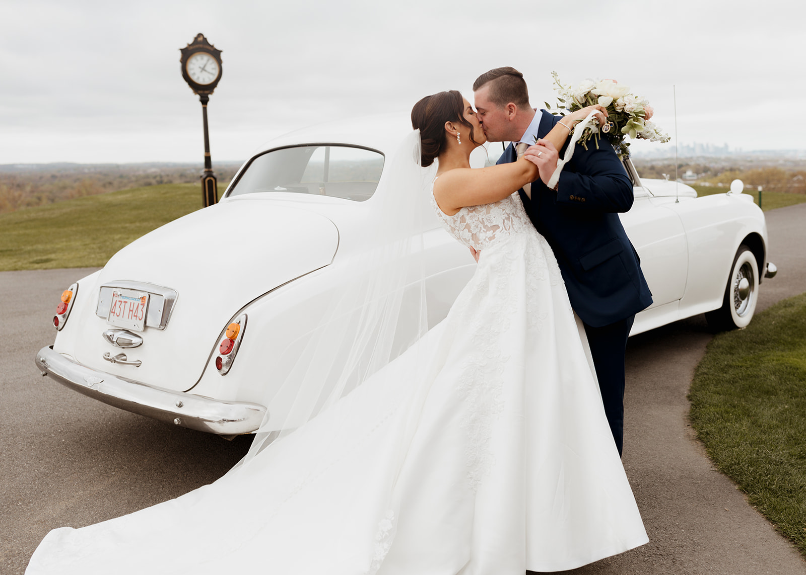 Boston couple at their Granite Links wedding in front of their rented Bentley
