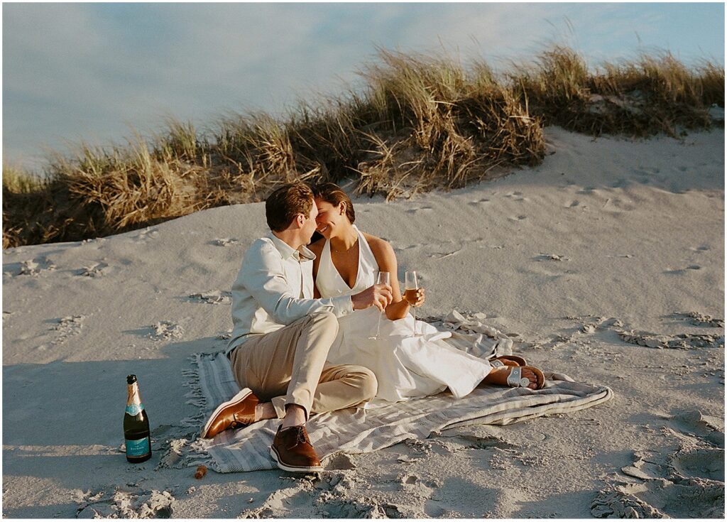 Couple taking beach engagement photos in Gloucester, MA