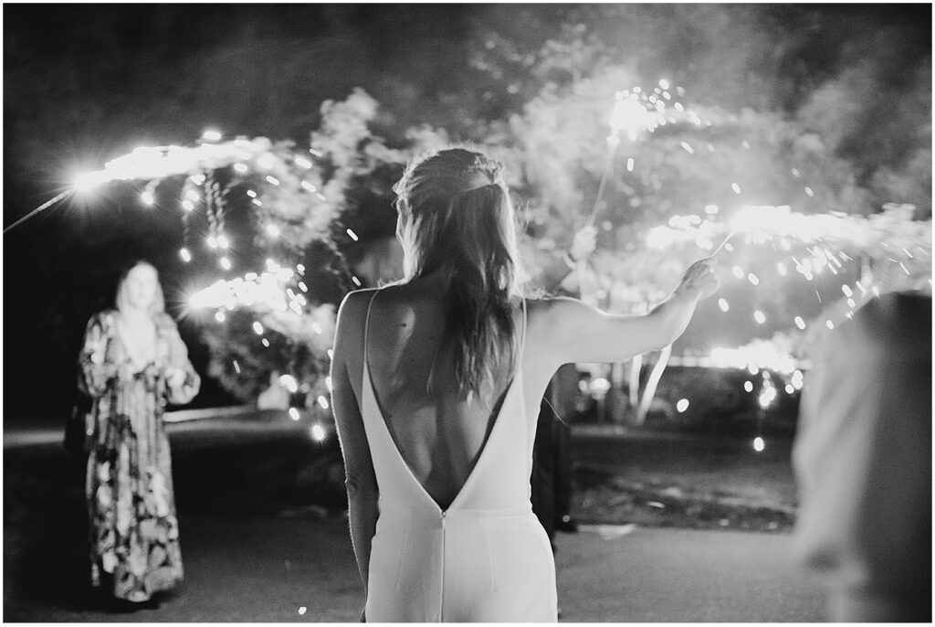 Bride in Boston with sparklers representing what to look for in wedding photographer reviews
